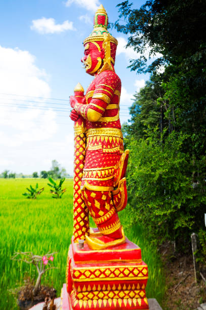 istock Red colored thai warrior statue  at trees in landscape 1754302373