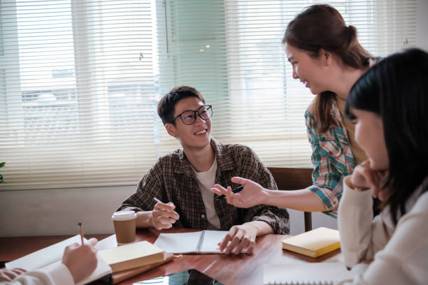 istock Happy diverse college students working together on study project in university classroom. 1754303840