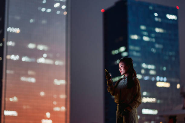 istock Young businesswoman using smartphone in financial district 1754304912