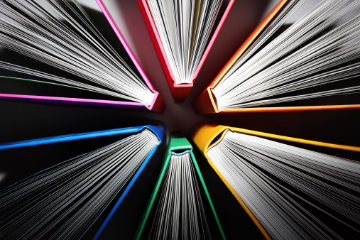 Fanned out colorful books forming an abstract pattern of explosion.