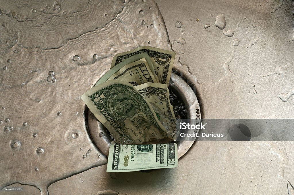 Money Down the Drain-englische Redewendung - Lizenzfrei Money Down The Drain - englische Redewendung Stock-Foto