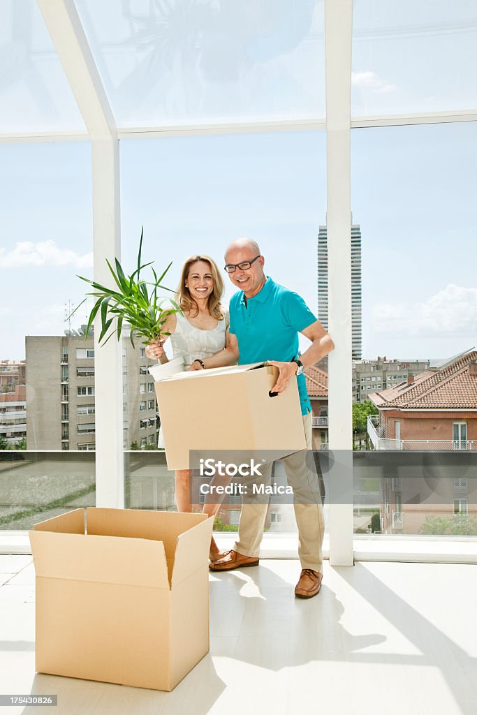 Adult couple relocating Adult couple relocating un a luxyry penthouse. Blue Stock Photo