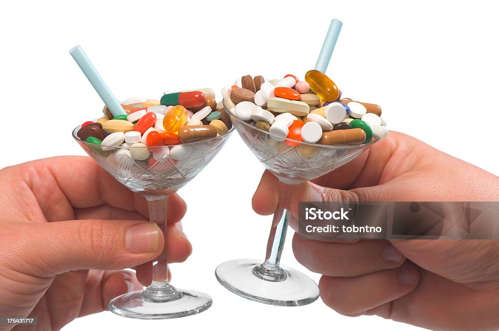 drug cocktails: cheers! two hands clinking their drug cockatils Cocktail Stock Photo