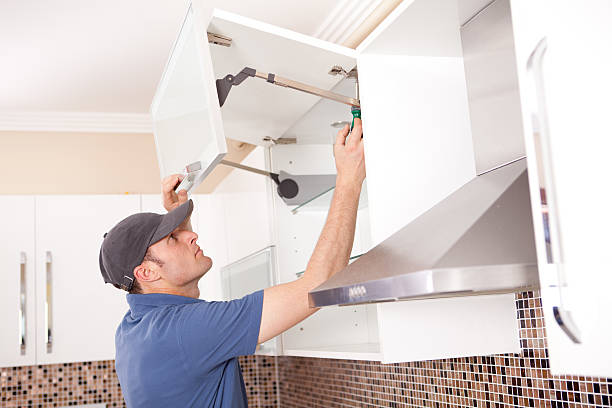 Carpenter Carpenter is working in kitchen. kitchen cabinet refacing stock pictures, royalty-free photos & images