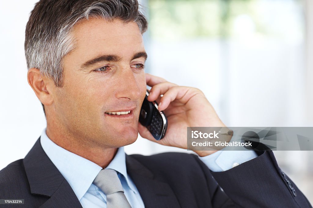 Middle-aged man attentively listening to colleague on phone An attractive middle-aged man with graying temples smiles slightly as he listens closely to a phone call. Appearing pensive and professional as he holds a cell phone to his ear, the man is dressed in a dark suit with a light-blue shirt and a gray tie. Adult Stock Photo Middle-aged man attentively listening to colleague on phone An attractive middle-aged man with graying temples smiles slightly as he listens closely to a phone call. Appearing pensive and professional as he holds a cell phone to his ear, the man is dressed in a dark suit with a light-blue shirt and a gray tie. Adult Stock Photo
