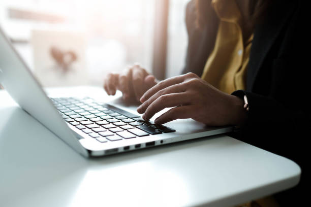 istock Female writer typing using laptop keyboard at her workplace in the morning. Woman writing blogs online, side view close-up picture. 1754322378