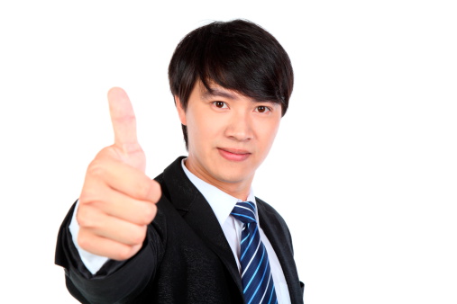 White background PortraitClose-up of a young man showing thumbs up