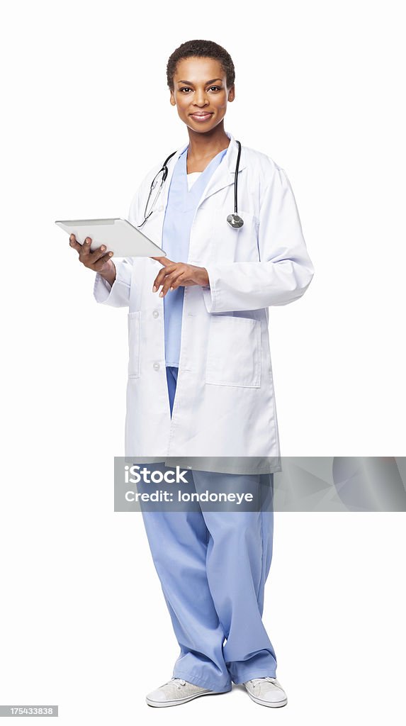 African American Female Doctor Using a Digital Tablet - Isolated Full length portrait of a confident African American female doctor using a digital tablet. Vertical shot. Isolated on white. African Ethnicity Stock Photo