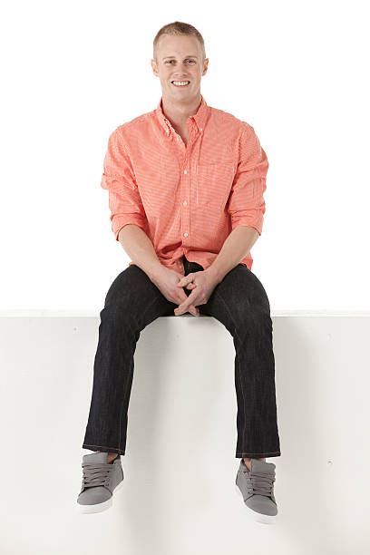 istock Man sitting on the ledge of a wall 175433899