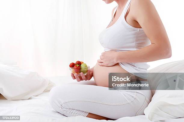 Pregnant Young Woman Holding Fruit Bowl Stock Photo - Download Image Now - 20-29 Years, 30-39 Years, Abdomen