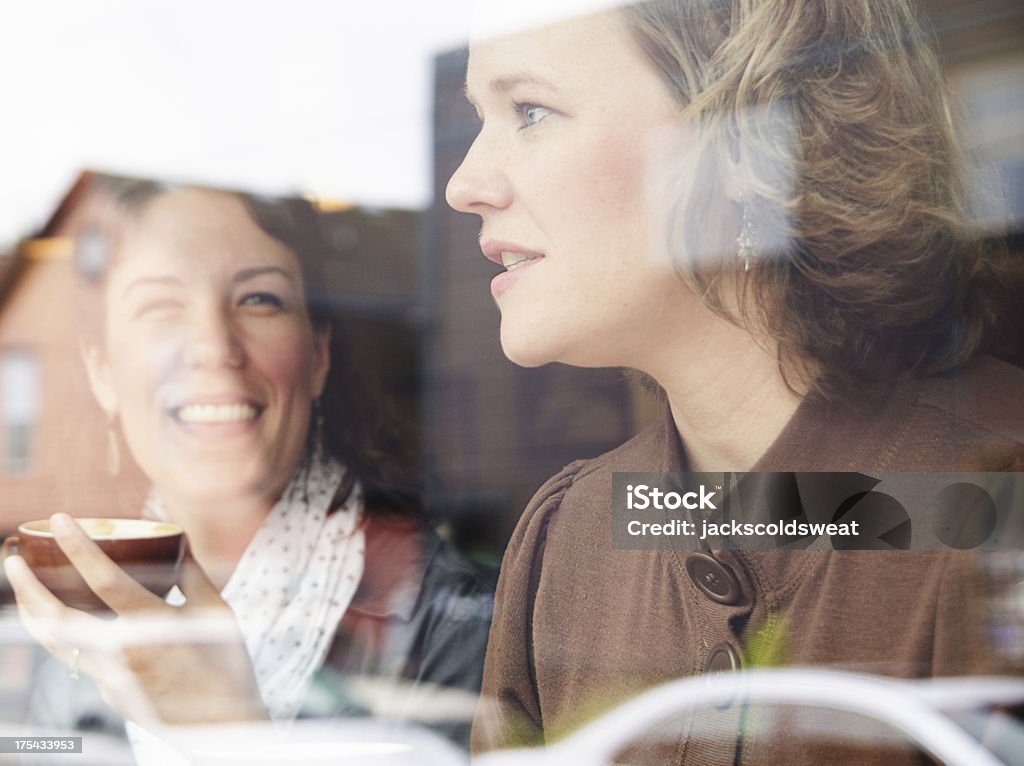 Friends chatting in a coffee shop Friends chatting in a coffee shop and laughing. 30-34 Years Stock Photo