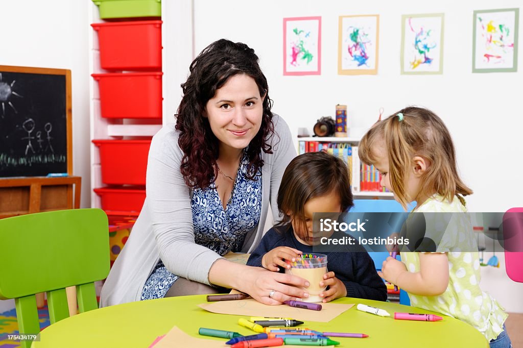 Маленькие дети, собирать, окраска карандаши/мелки с их Учитель - Стоковые фото Дошкольное учреждение роялти-фри