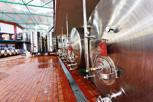 istock Stainless steel tanks on wet brick floor at modern winery 175434370