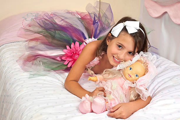 Cute girl hugging each other her doll Cute girl loving her doll crown daisy stock pictures, royalty-free photos & images