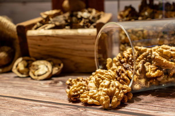 istock Peeled walnuts coming out of a jar on a table 1754354673
