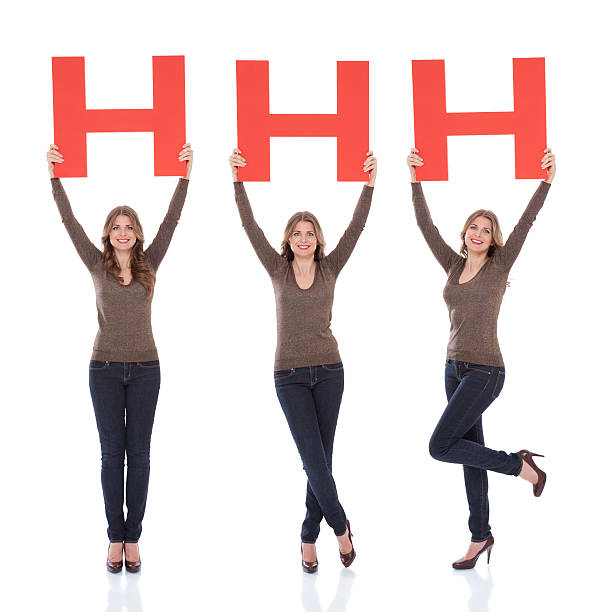 Woman holding letter H.