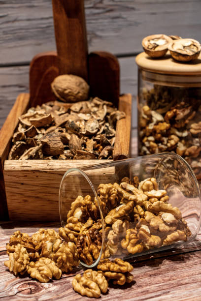 istock Peeled walnuts coming out of a jar on a table 1754355234