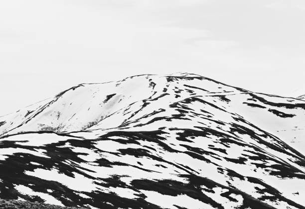 istock Black and white abstract minimalist picture with a mountain covered in snow 1754362603