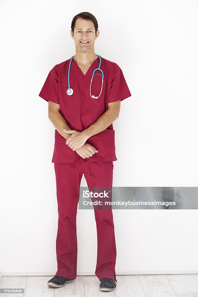 Studio Portrait Of Doctor Leaning Against White Background Studio Portrait Of Doctor Leaning Against White Background Smiling At Camera 30-39 Years Stock Photo