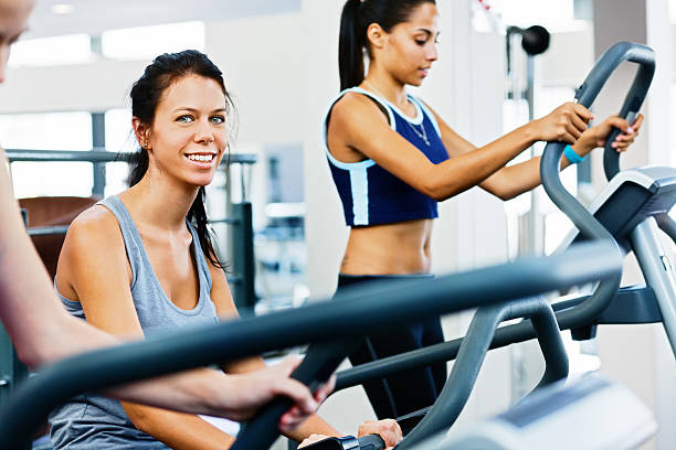 Pretty Women Staying Fit By Using Gym Equipment Stock Photo - Download  Image Now - 20-29 Years, Adult, Adults Only - iStock