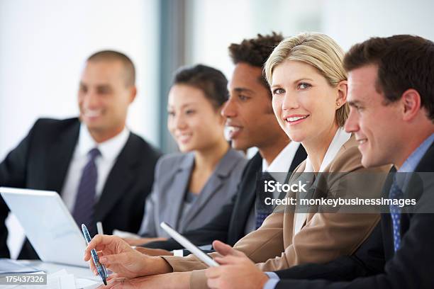Portrait Of Female Executive Attending Office Meeting With Colle Stock Photo - Download Image Now