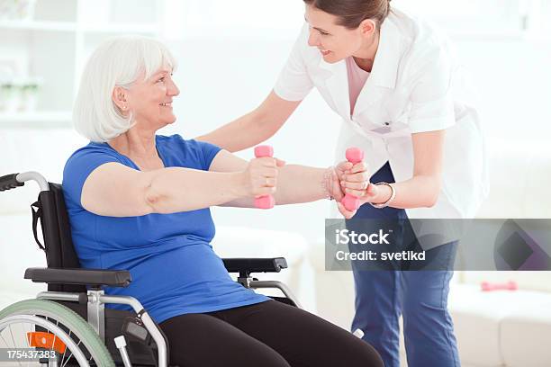 Senior Woman Exercising Stock Photo - Download Image Now - People, Wheelchair, 60-64 Years