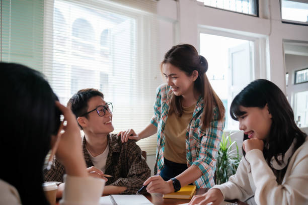 istock group of happy, diverse young Asian university students is working on a group project or preparing for the exam while sitting indoor together. Friendship and education concepts 1754374135