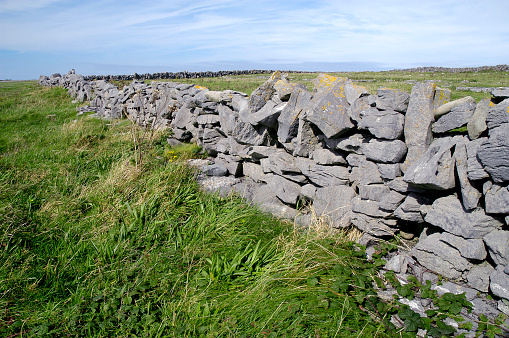 A stacked-stone fence winds its way around the border of The Burren in County Clare, Ireland.