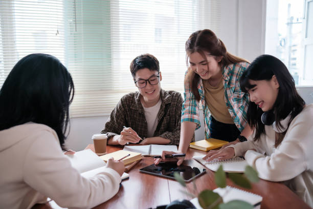 istock group of happy, diverse young Asian university students is working on a group project or preparing for the exam while sitting indoor together. Friendship and education concepts 1754376729