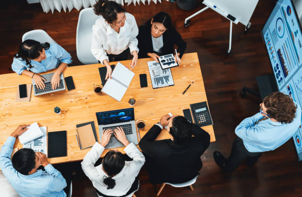 istock Wide top view diverse analyst team analyzing financial data. Habiliment 1754382503