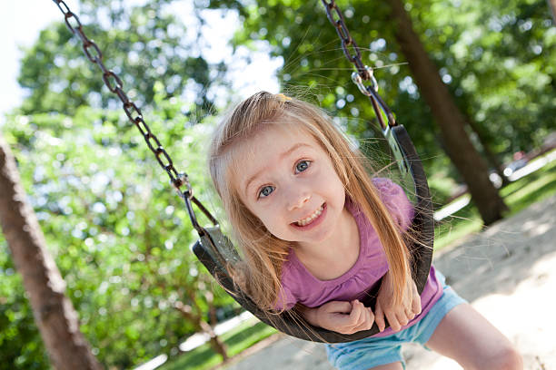 istock Little Girl Silly On Swing 175438946