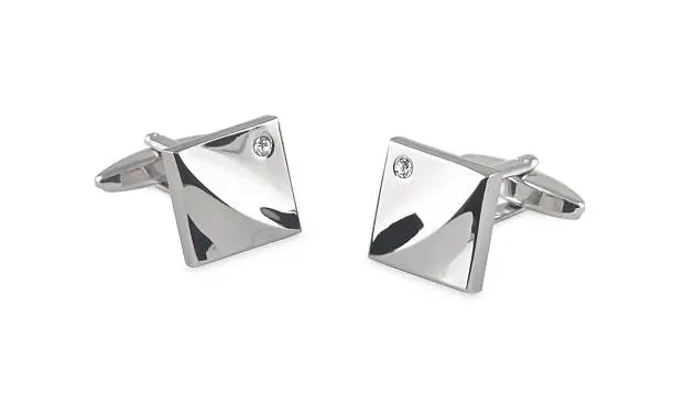 a pair of shiny bright cufflinks with contoured square faces and round cut crystals in the corners.
