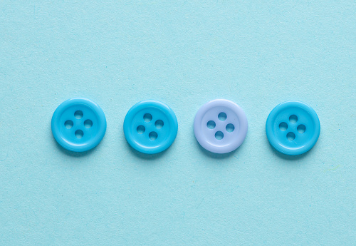 Plastic blue buttons on a blue background