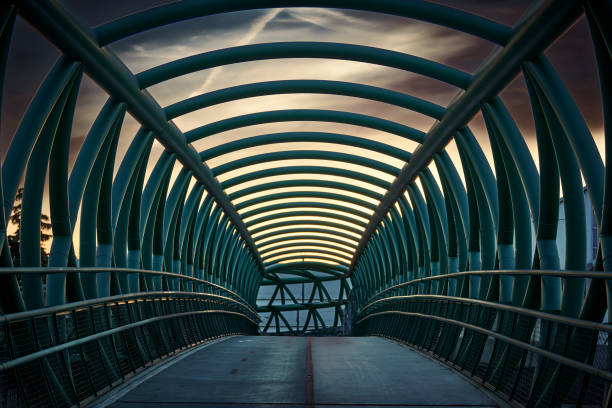 Magnificent Metallic Green Pedestrian Bridge Raised Without People On A Cloudy Afternoon