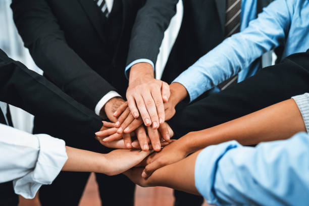 istock Multiracial business people make synergy hand stack together. Habiliment 1754398917