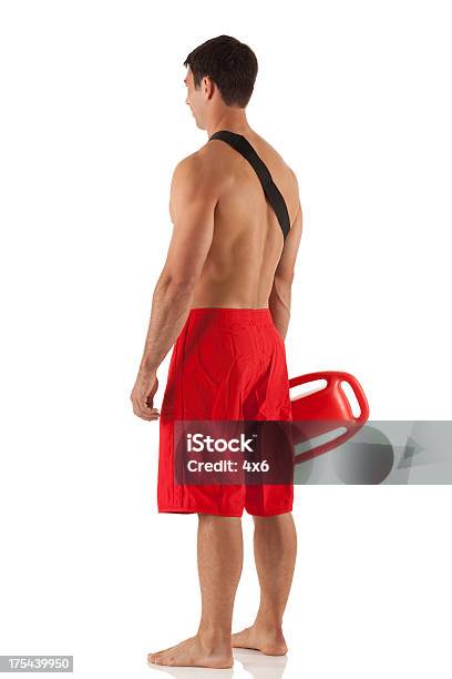 Lifeguard Standing With A Float Stock Photo - Download Image Now - Lifeguard, Men, Rear View