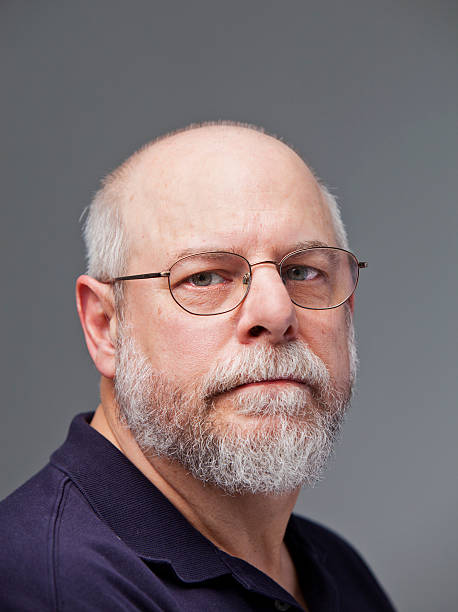 istock Portrait of serious senior man, grey background. 175440171