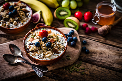 Granola and yogurt bowl on rustic wooden table