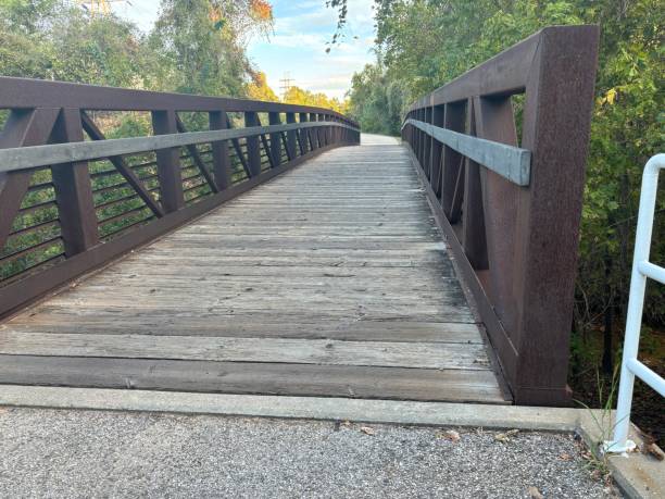 istock Wooden footbridge on walking path 1754407537