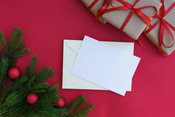 istock Christmas still life. Blank greeting card, invitation mockup. Pine tree branches, presents and Christmas decorations. 1754409308