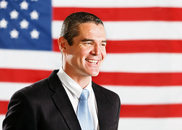 istock Handsome confident-looking businessman in front of US flag 175441413