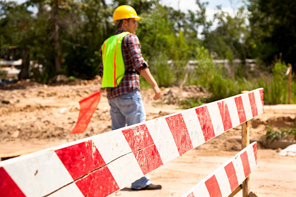 istock Road construction flagman.  Selective focus at mid point of barricade. 175441512