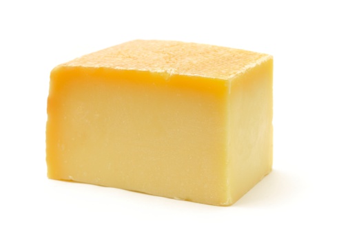 Swiss Gruyere cheese isolated on a white background.