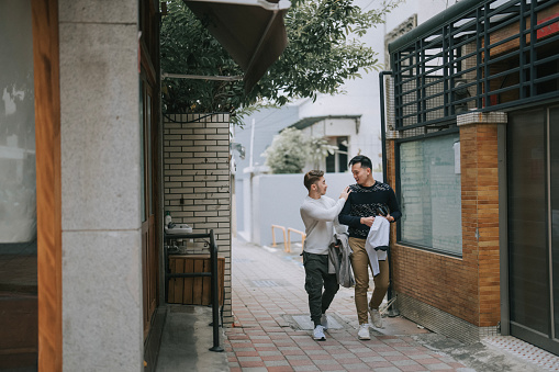 Asian Chinese gay couple tourist exploring Tainan city street