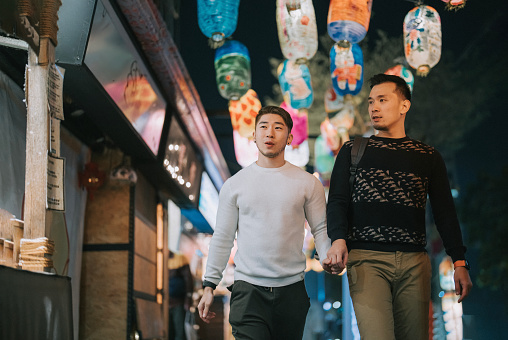 Asian Chinese gay couple tourist exploring Tainan city street at night