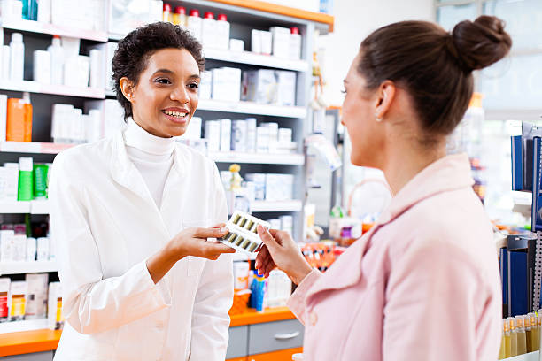 istock Pharmacist giving pills in blister pack to a customer 175441798
