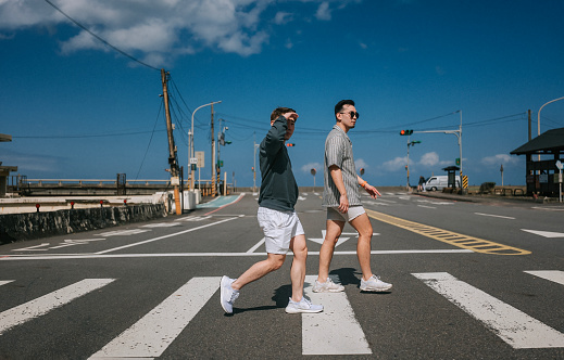 Asian Chinese gay couple tourist crossing zebra line in Juifen , Taiwan Tourist Attraction