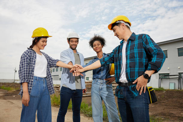 istock group of workers or architect join hands from success at work and project on the construction site 1754418737