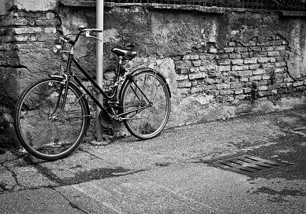 istock Bicycle Fastened To A Pole Near Brick Wall 175441913