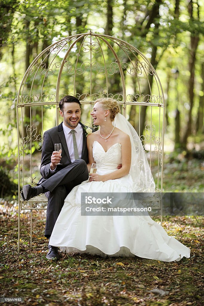 Newlyweds sitting and laughing together Newlyweds sitting and laughing together. Adult Stock Photo